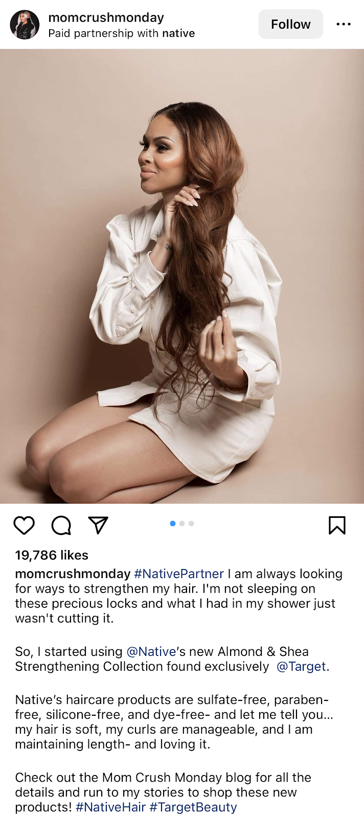 Instagram paid partnership post showing an influencer holding her long wavy hair, introducing a haircare brand to her audience