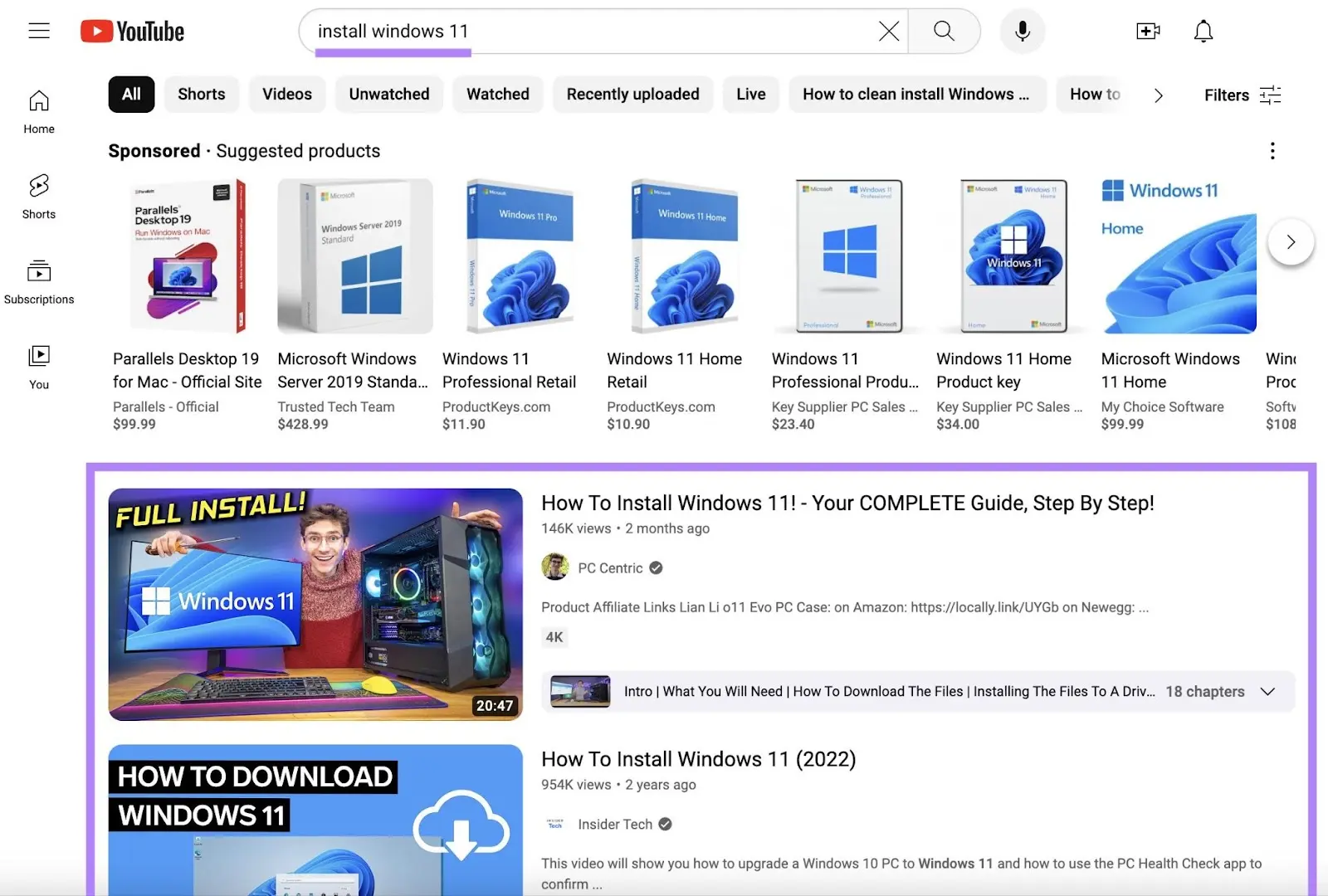 YouTube hunt  results for 'install windows 11' showing sponsored merchandise  ads and integrated  results beneath  them