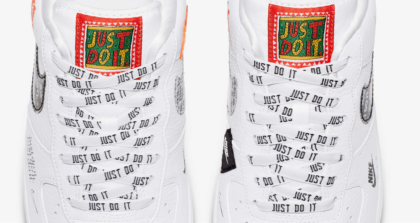 Nike shoes with "Just Do It" slogan written on the tongue and laces