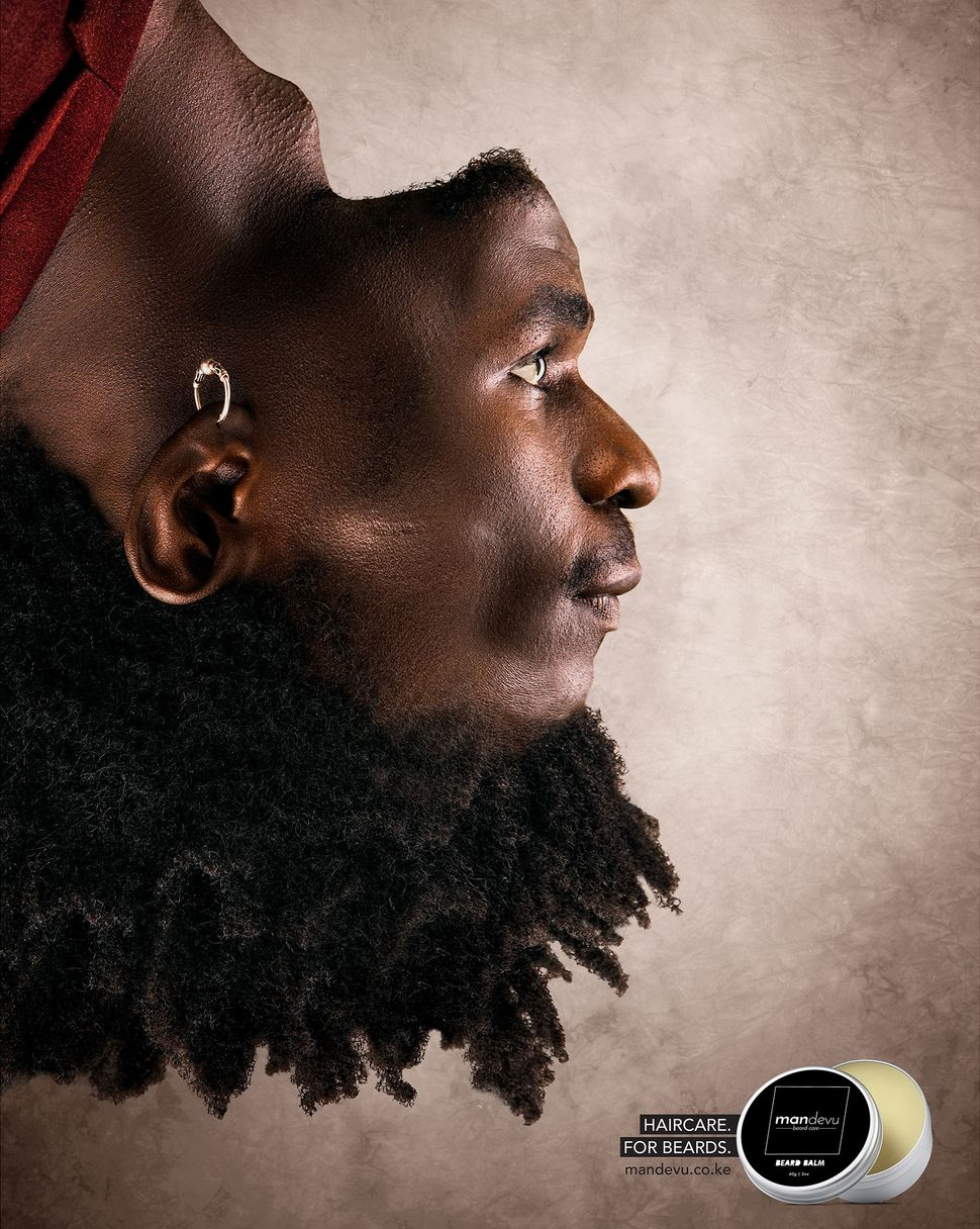 A mag  advertisement  for beard attraction   products showing a man's caput  upside down   but its look   edited successful  the regular   position, causing his hairsbreadth  to look  arsenic  his beard.