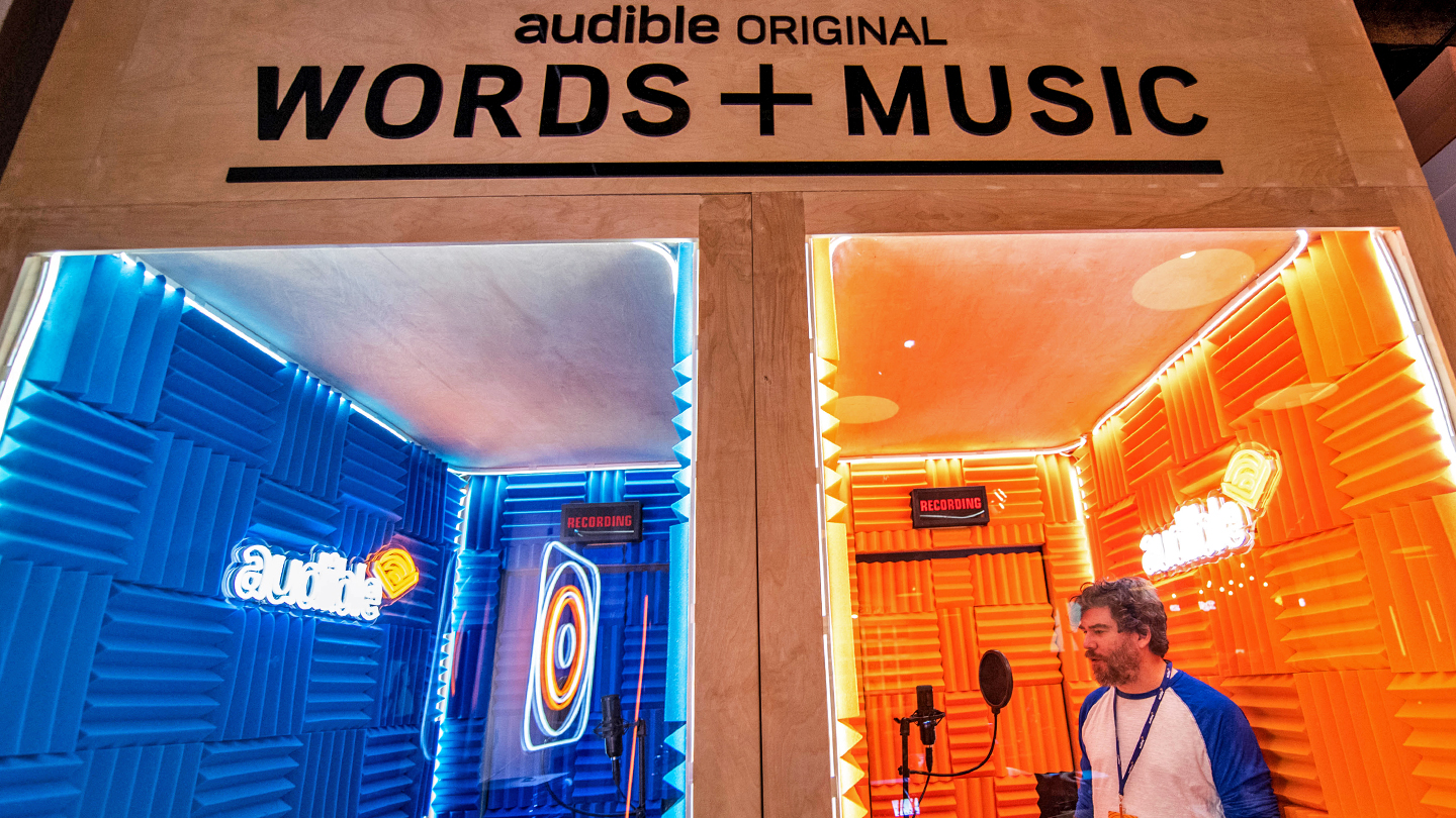 Audible trade fair booth showing two rooms where people can record both podcasts and music.