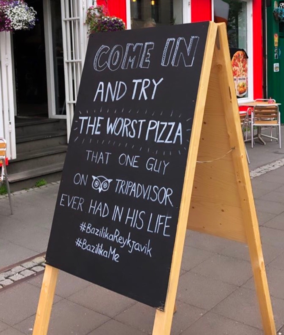 Iceland's restaurant outdoor menu stand with "Come in and try the worst pizza that one guy on Tripadvisor ever had in his life" copy