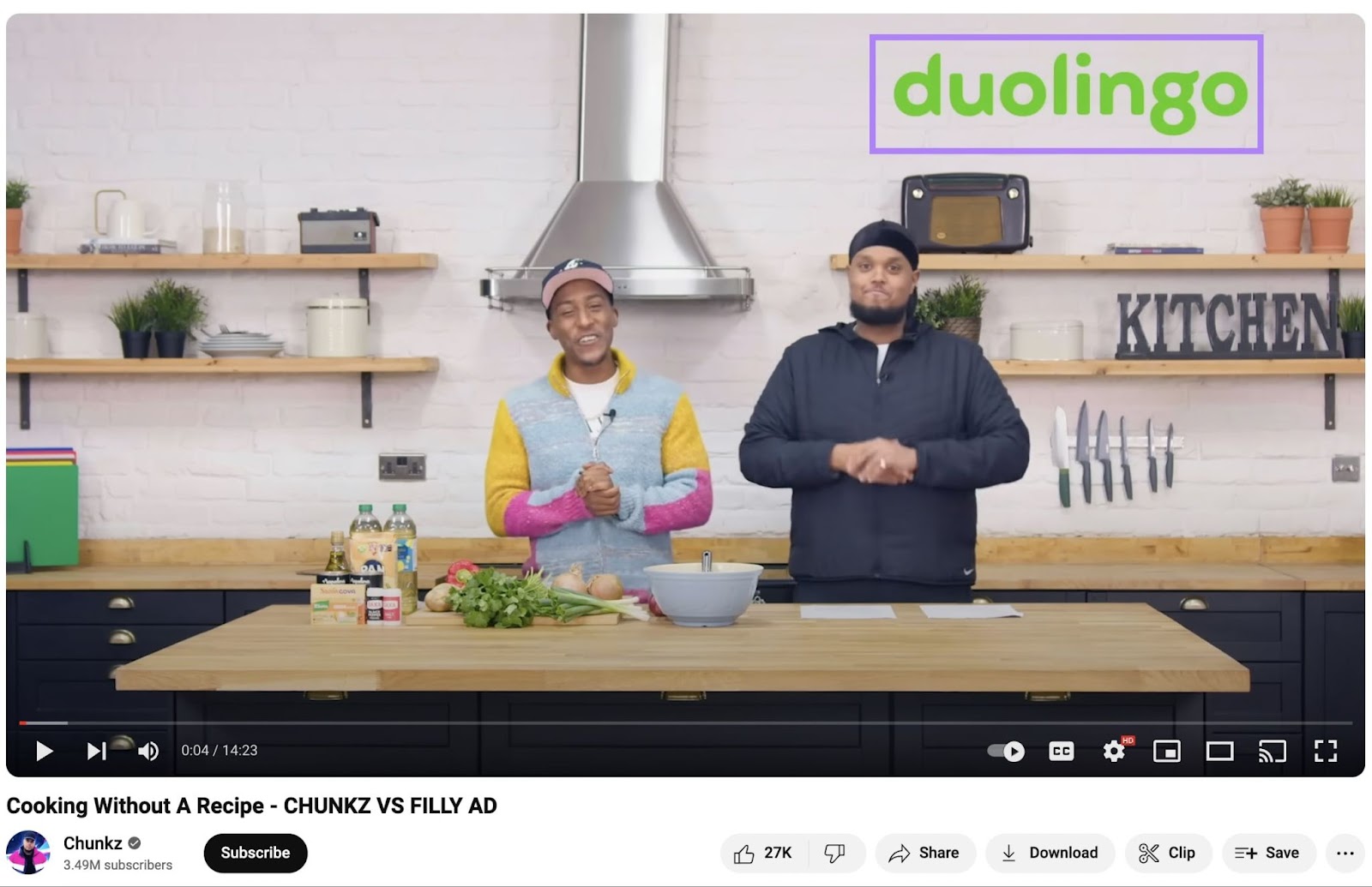 Cooking Youtube video with two men in a kitchen ready to cook a recipe. Duolingo logo in top right corner