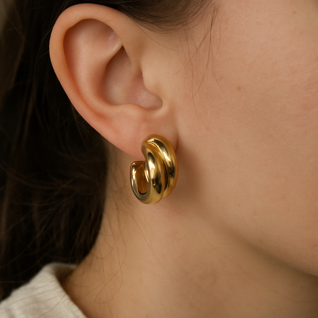 close-up of gold earrings on ear