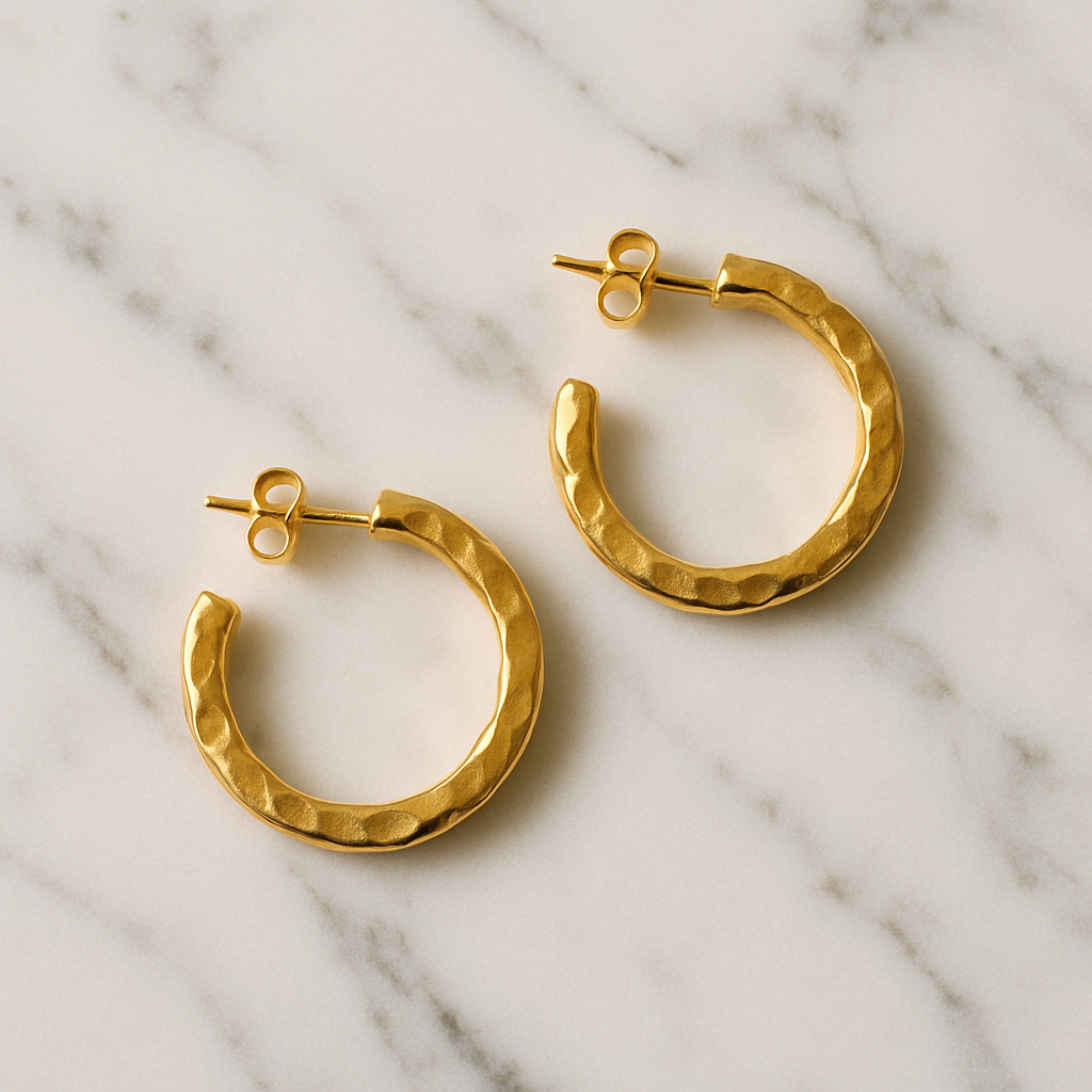 gold earrings on marble background