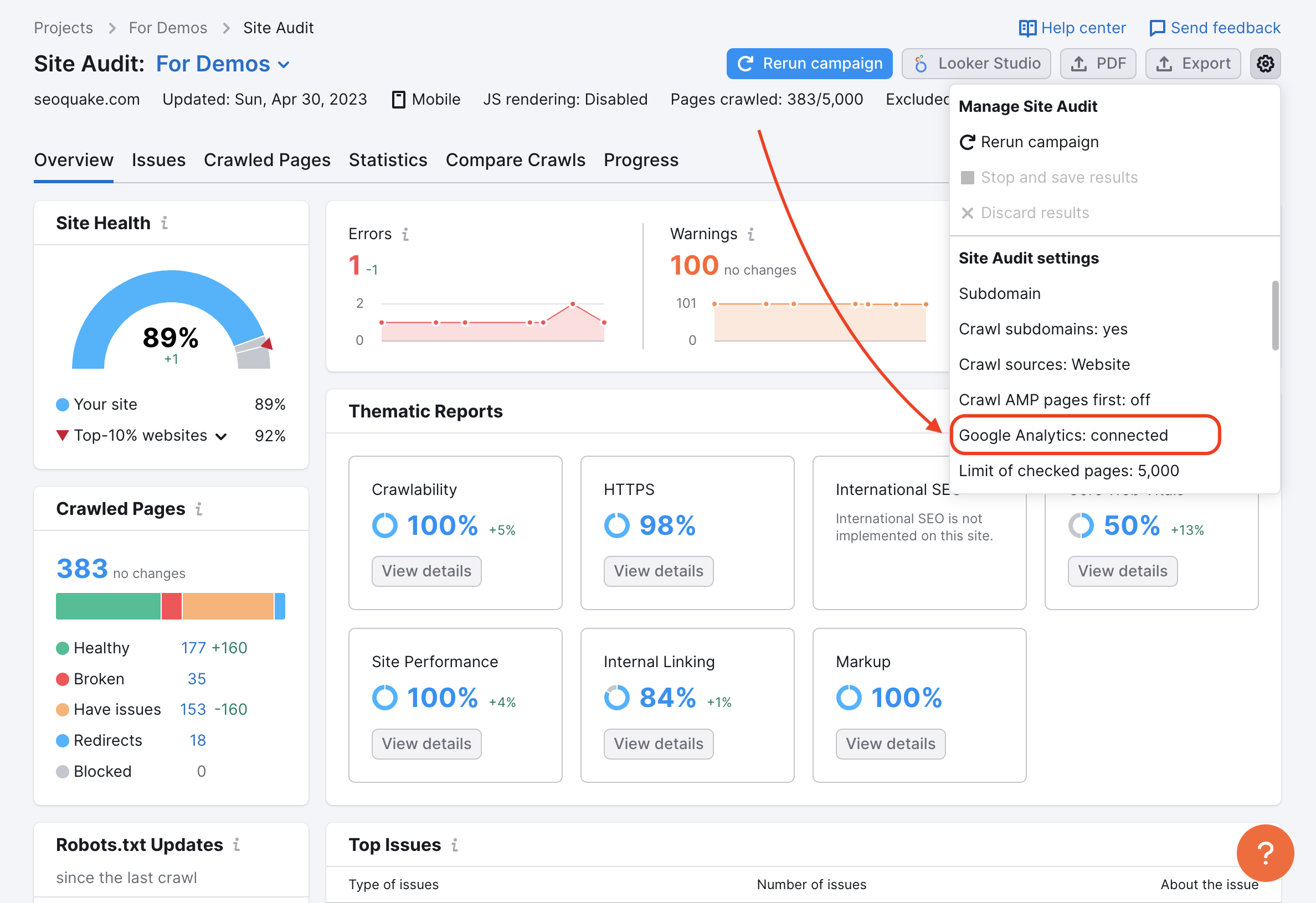 Site Audit Overview with a red arrow pointing to the Google analytics integration in the drop-down settings menu in the top-right corner. 